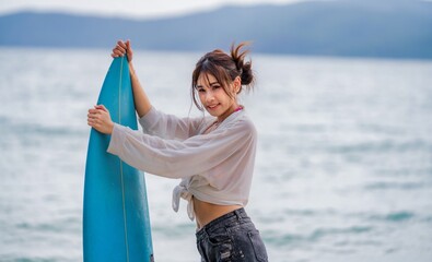 Young woman enjoying surfing on a beautiful beach at sunset, showcasing a vibrant blue surfboard