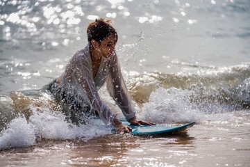 Exciting surfing experience in the ocean during a sunny afternoon with splashing waves