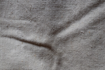 Light coarse fabric with thick threads, textured textiles of large weave as texture for background