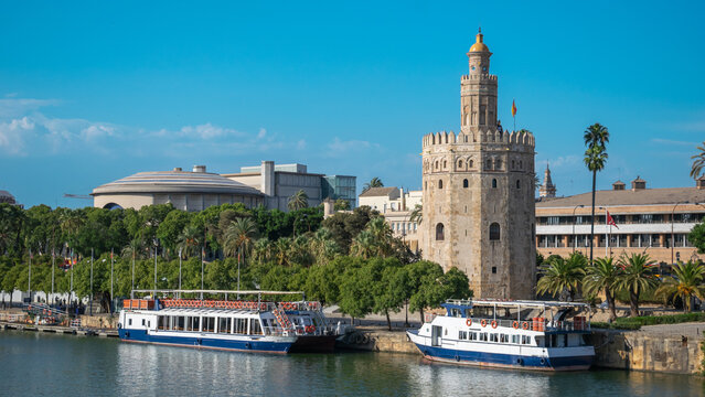 La historica torre del oro siglo XIII a orillas del rio Guadalquivir con barcos de recreo en la ciudad de Sevilla, Espa&ntilde;a