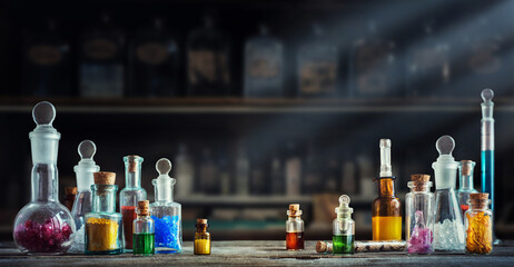 A bottle of poison on a background of old medical, chemistry and pharmacy glass. Chemistry and...