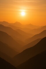 Fototapeta premium Epic mountain silhouette landscape during dramatic golden hour sunset with layered atmospheric perspective