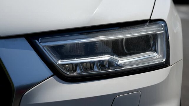 Seamless loop animation slideshow of car headlight brake light urban street background backdrop. Close up of a car. 