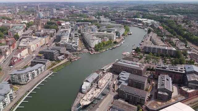 Bristol UK: 28th July 2025: Drone view of the Bristol Harbourside with boats and colourful houses on the River Avon. 360-degree pan