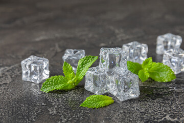 Mint and ice on texture background. Green fresh mint and ice cube. Mint leaves, ice cube and water...