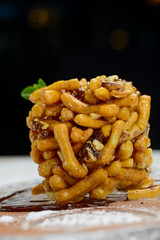 oriental dessert in a plate on a dark background