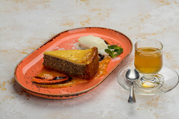 oriental dessert cake on a plate on a background with tea