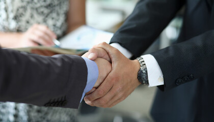 Business deals flourish with firm handshakes in a modern office setting during a bright afternoon