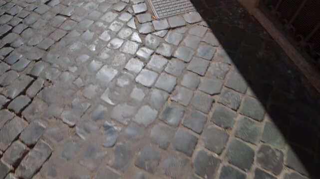 Old cobblestone street with uneven stone pattern creating textured surface, historic European road detail symbolizing vintage urban architecture and cultural heritage