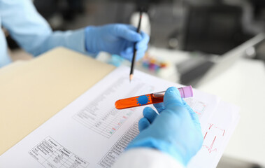 Laboratory technicians conducting tests in a modern lab setting with colorful samples and thorough documentation