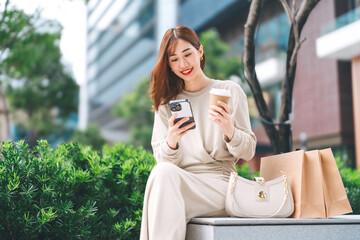 Adult asian business woman Influencer using smartphone review rating on social media wealthy urban lifestyle