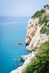 Stunning view of Calella de Palafrugell's pristine coastline featuring traditional whitewashed Mediterranean architecture, crystal-clear turquoise waters, and dramatic rocky outcrops along Costa Brava