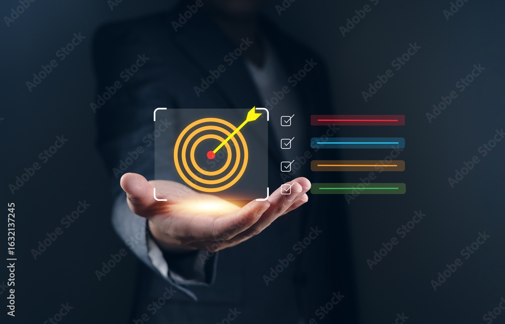 Poster business goal setting and task management a businessman holds a holographic target symbolizing goals