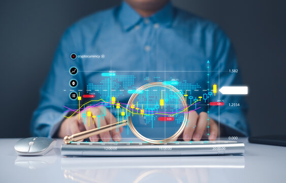 Businessman analyzing stock market Futuristic interface displaying data analytics with a magnifying glass effect and interacting with it. financial graphs and calculator of investment trading economy