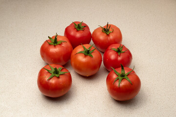 Home-grown tomatoes close-up. Ripe red tomatoes on the kitchen table