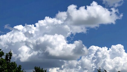 Obraz premium Dramatic clouds in a bright blue sky create a picturesque summer day