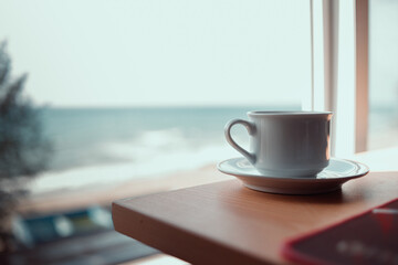 hot cup of coffee on the table in the morning, relaxing time, by the window