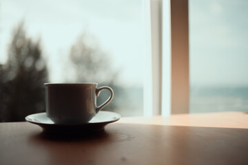 hot cup of coffee on the table in the morning, relaxing time, by the window