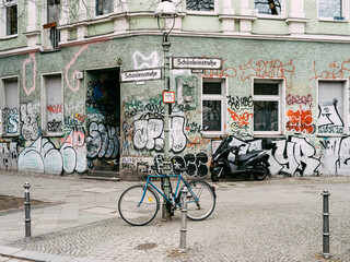 Urban Side Street with Graffiti Covered Walls Bicycle and Scooter in European City Setting