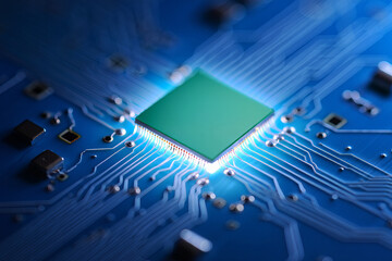 Illuminated green microchip on a blue circuit board