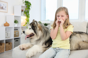 Girl suffering from allergy with her dog at home
