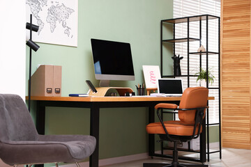 Stylish workplace with modern computer, other devices and stationery on wooden desk indoors