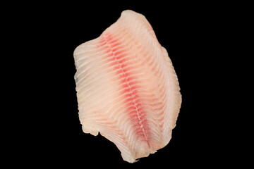 Fresh tilapia fillet on black background, top view.