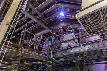 Male work inspection process stainless steel tanks and pipe with pressure meter in equipment tank facility for cellar at the with vertical stainless