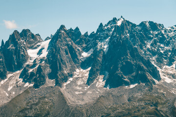 Stunning mountain range near Chamonix in the French Alps under clear blue sky. Jagged peaks, rocky...