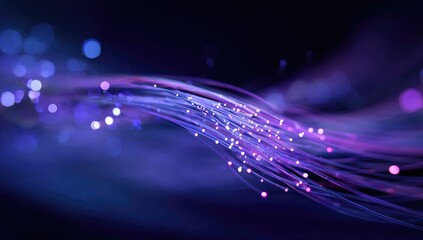 Abstract, glowing, purple and blue fiber optic lines against a dark background with bokeh