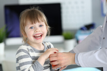 Smiles brighten the room during a friendly pediatric check-up in a bright clinic environment