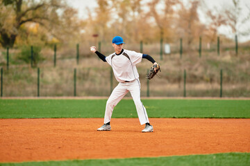 Talented teenage boy showcases skills playing baseball on a vibrant green field