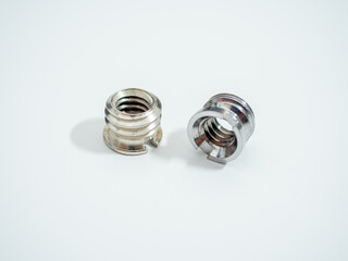 Two metal screw adapters for camera tripods are shown on a clean white background in a studio setting.
