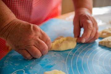 a woman makes a lot of pies out of dough. High quality photo