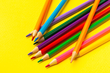 Colored pencils on a bright colored background. Equipment for coloring. Stationery for creativity.Back to school. Flatlay. Children's Creativity and Education. Rainbow.Space for text. Copy space.