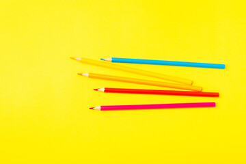 Colored pencils on a bright colored background. Equipment for coloring. Stationery for creativity.Back to school. Flatlay. Children's Creativity and Education. Rainbow.Space for text. Copy space.