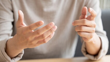 Hand gesture communication conversation body language close up adult casual expressive discussion emotion relaxed indoor human interaction