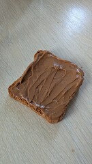 Indulge in the Delight of Spreading Creamy Peanut Butter Generously on Crispy Toast