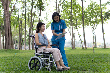 Fototapeta premium A friendly nurse assists an elderly woman in a wheelchair, providing care, support, and conversation during recovery in a retirement or healthcare setting.