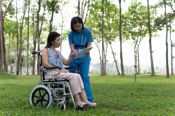 A friendly nurse assists an elderly woman in a wheelchair, providing care, support, and...