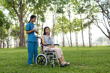 A friendly nurse assists an elderly woman in a wheelchair, providing care, support, and...