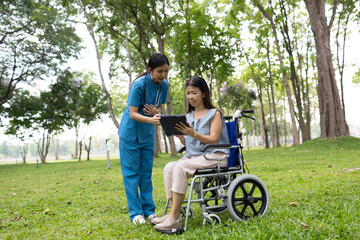 Fototapeta premium A friendly nurse assists an elderly woman in a wheelchair, providing care, support, and conversation during recovery in a retirement or healthcare setting.