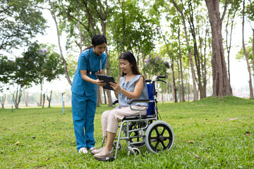 A friendly nurse assists an elderly woman in a wheelchair, providing care, support, and...