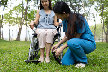A friendly nurse assists an elderly woman in a wheelchair, providing care, support, and...