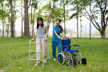 A friendly nurse assists an elderly woman in a wheelchair, providing care, support, and...