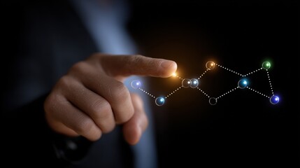 Fototapeta premium Close up of a hand touching a glowing network of interconnected nodes against a dark background