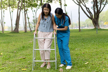 A friendly nurse assists an elderly woman in a wheelchair, providing care, support, and...