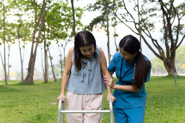 A friendly nurse assists an elderly woman in a wheelchair, providing care, support, and...