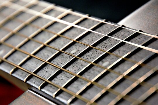 Black guitar with strings from close up	