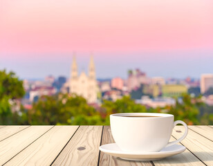 White Coffee Cup on Wooden Table with City Skyline at Sunrise